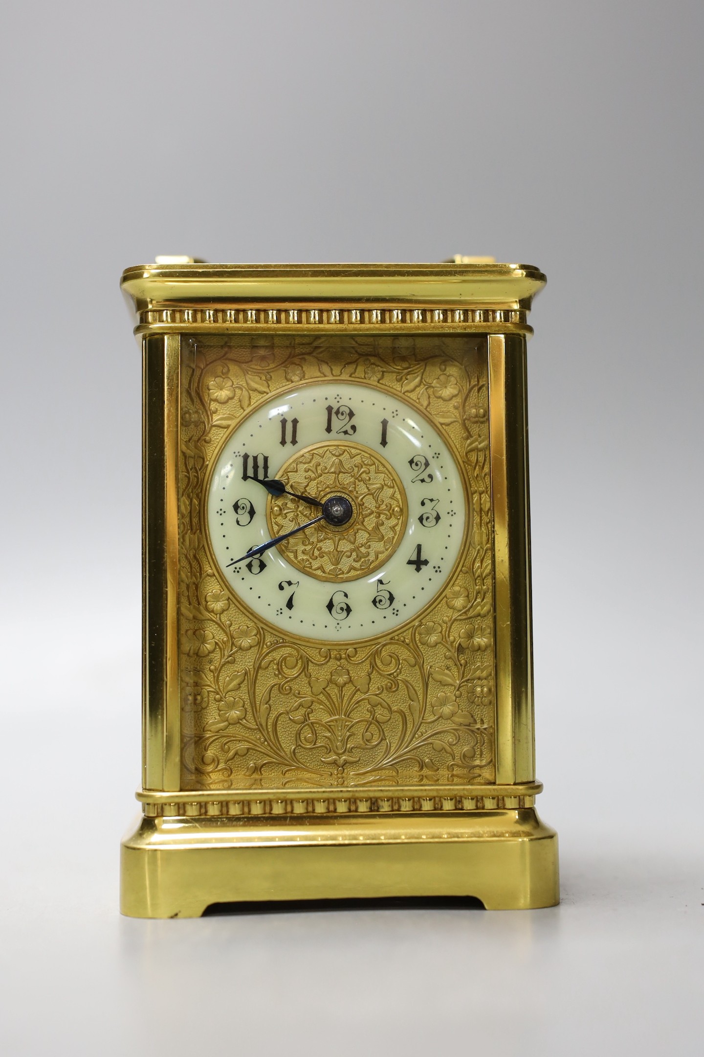 A cased French gilt brass carriage timepiece with relief cast dial and engraved presentation inscription - 14cm tall